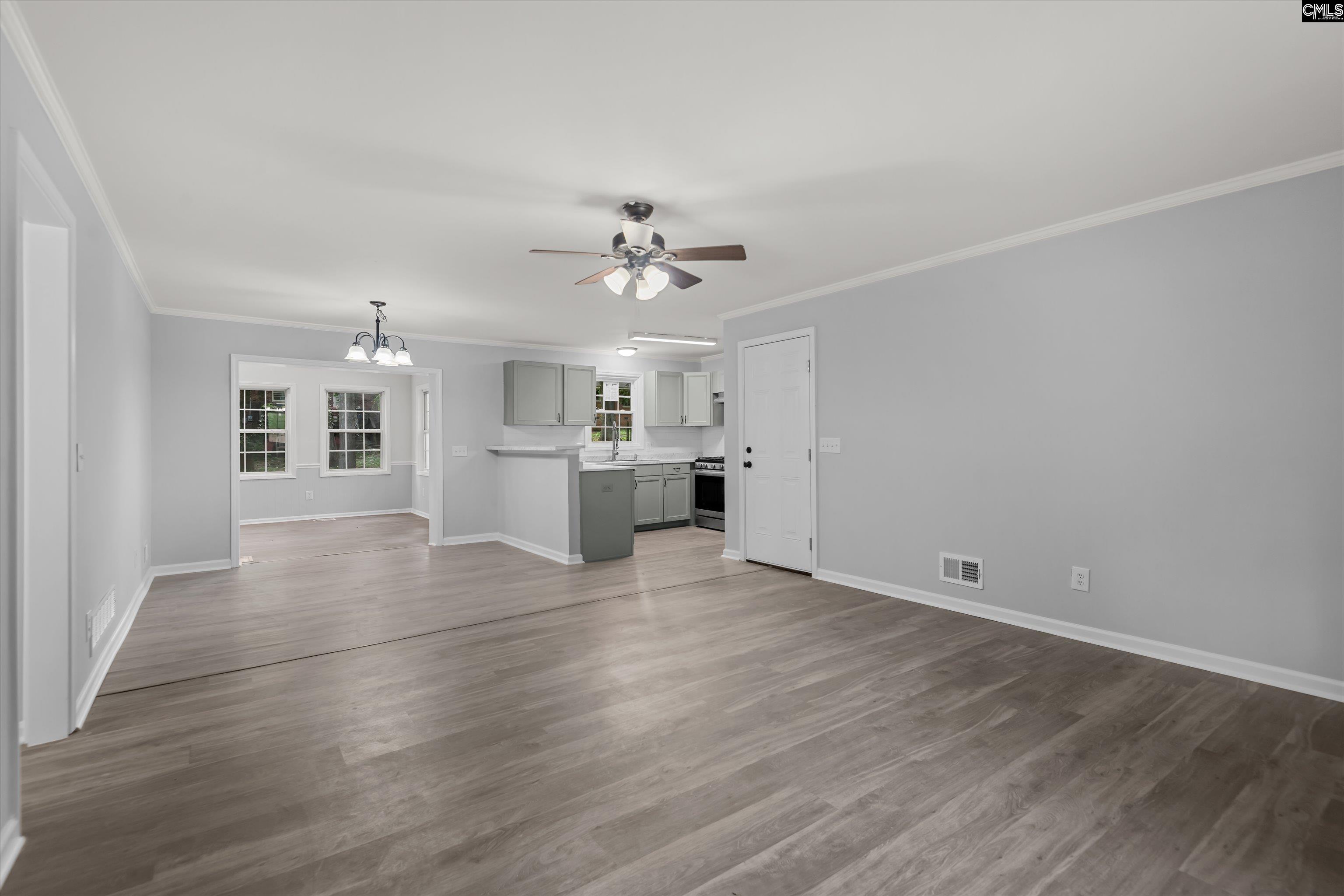 245 Piney Grove Road Columbia, SC 29210 - Photo 6 of 29 wooden floor in an empty room with a kitchen