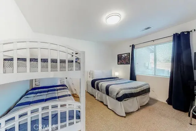 a spacious bedroom with a bed and a window