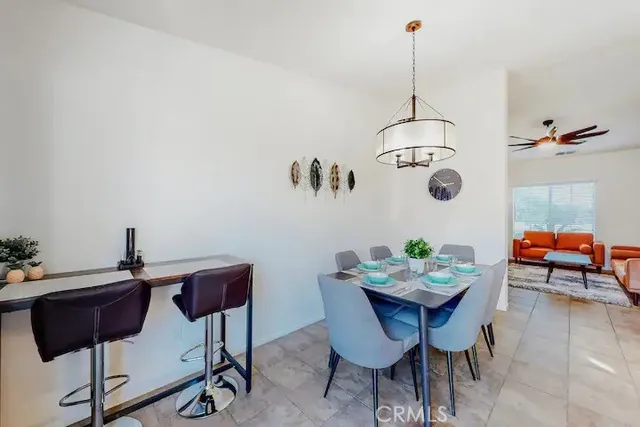 a view of a dining room with furniture and front door