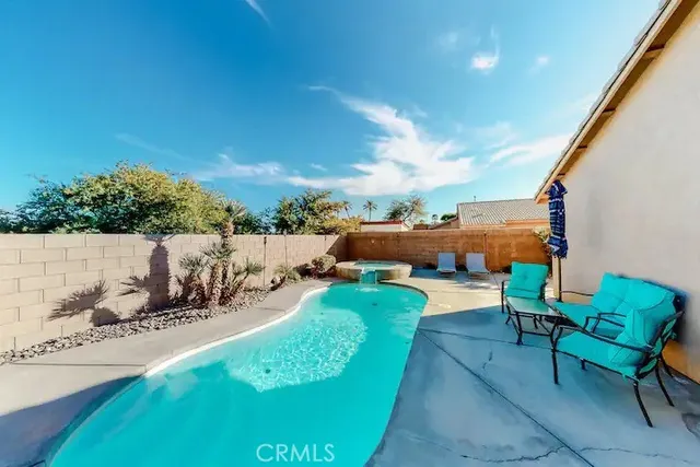a view of a chairs and table in backyard