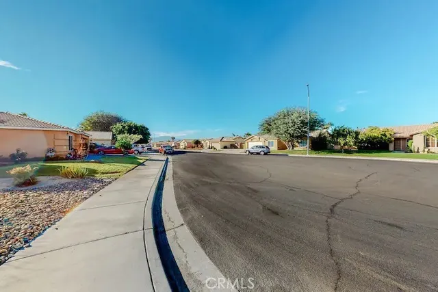 a view of a street with a cars parked on the road