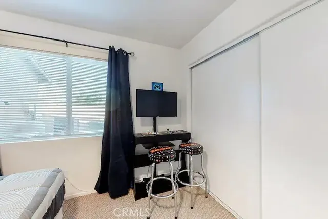 a living room with a flat screen tv and a window