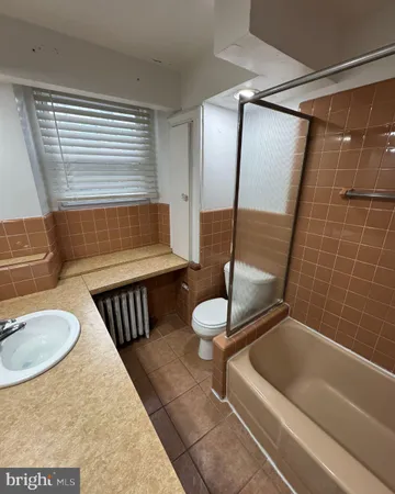 a bedroom with a bed lamp and a window