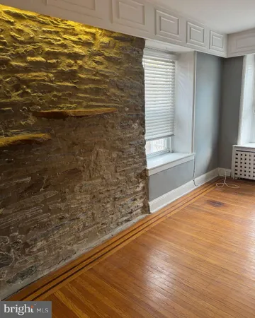 a view of wooden floor and windows in a room