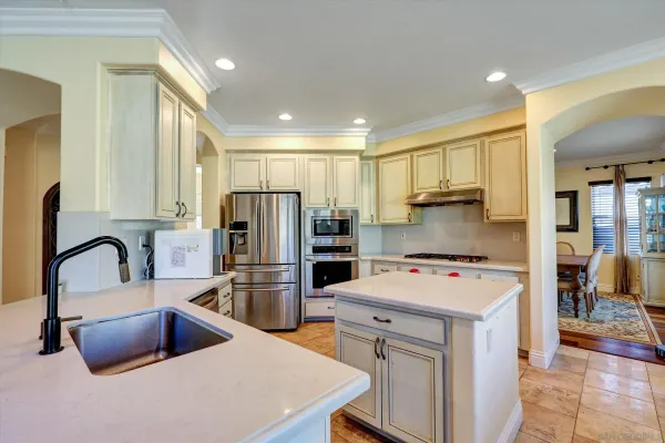 a kitchen with refrigerator a stove a sink and a microwave