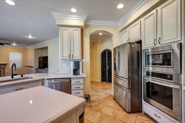 a kitchen with stainless steel appliances a refrigerator sink and microwave