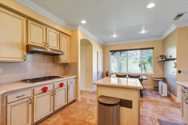 a kitchen with stainless steel appliances granite countertop a sink stove and cabinets