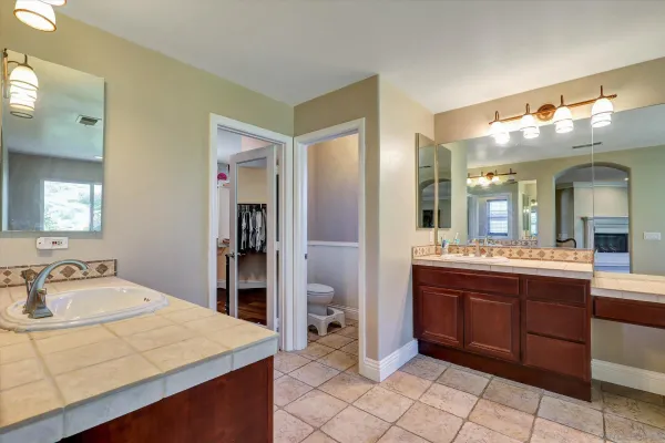 a spacious bathroom with a double vanity sink a mirror and a bathtub