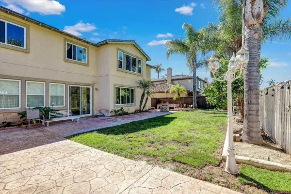 a pathway of a house with a small yard