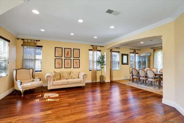 a living room with furniture and wooden floor