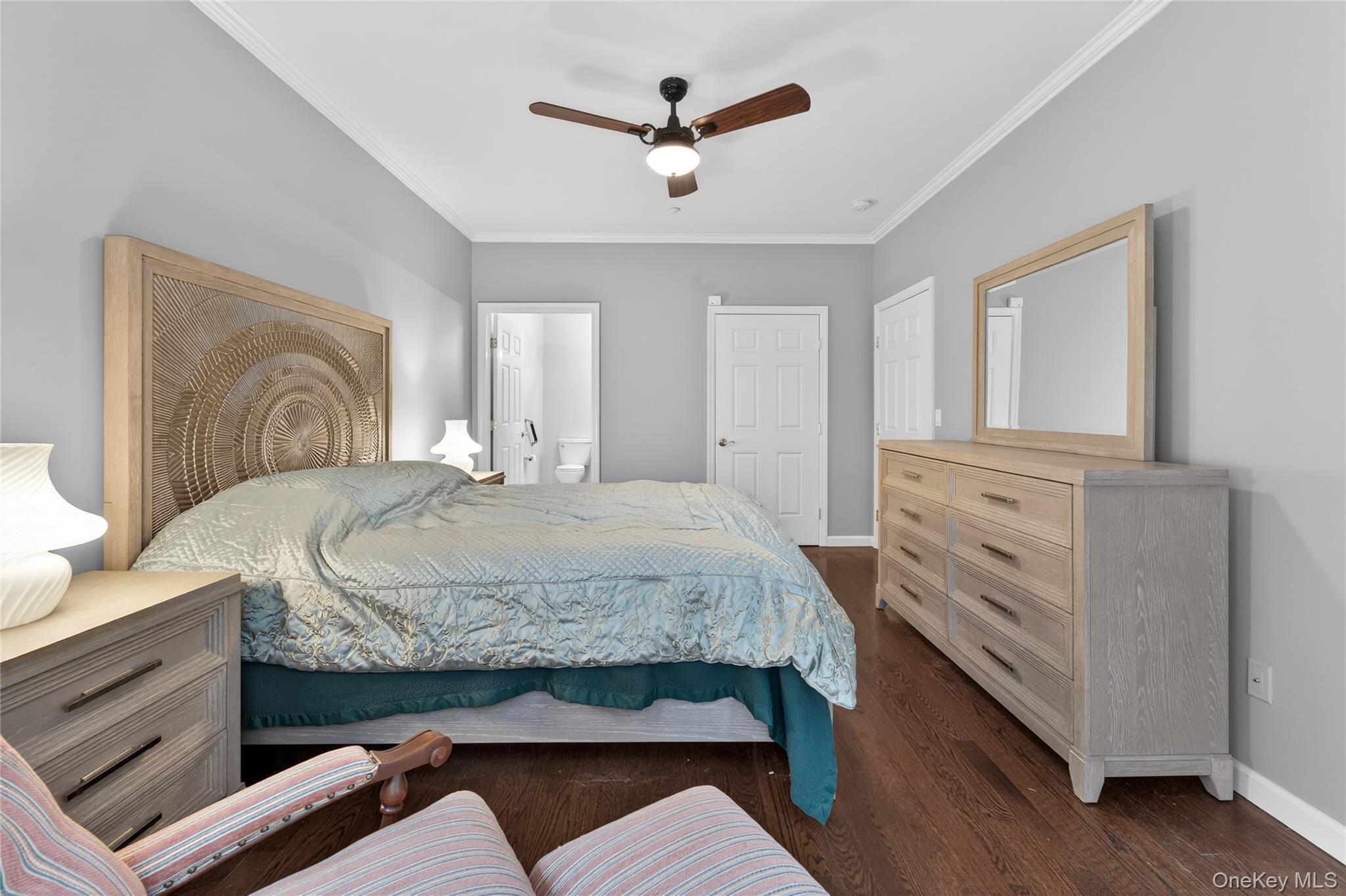 294 Spring Drive East Meadow, NY 11554 - Photo 14 of 31 Bedroom featuring ornamental molding, dark wood-type flooring, connected bathroom, and ceiling fan