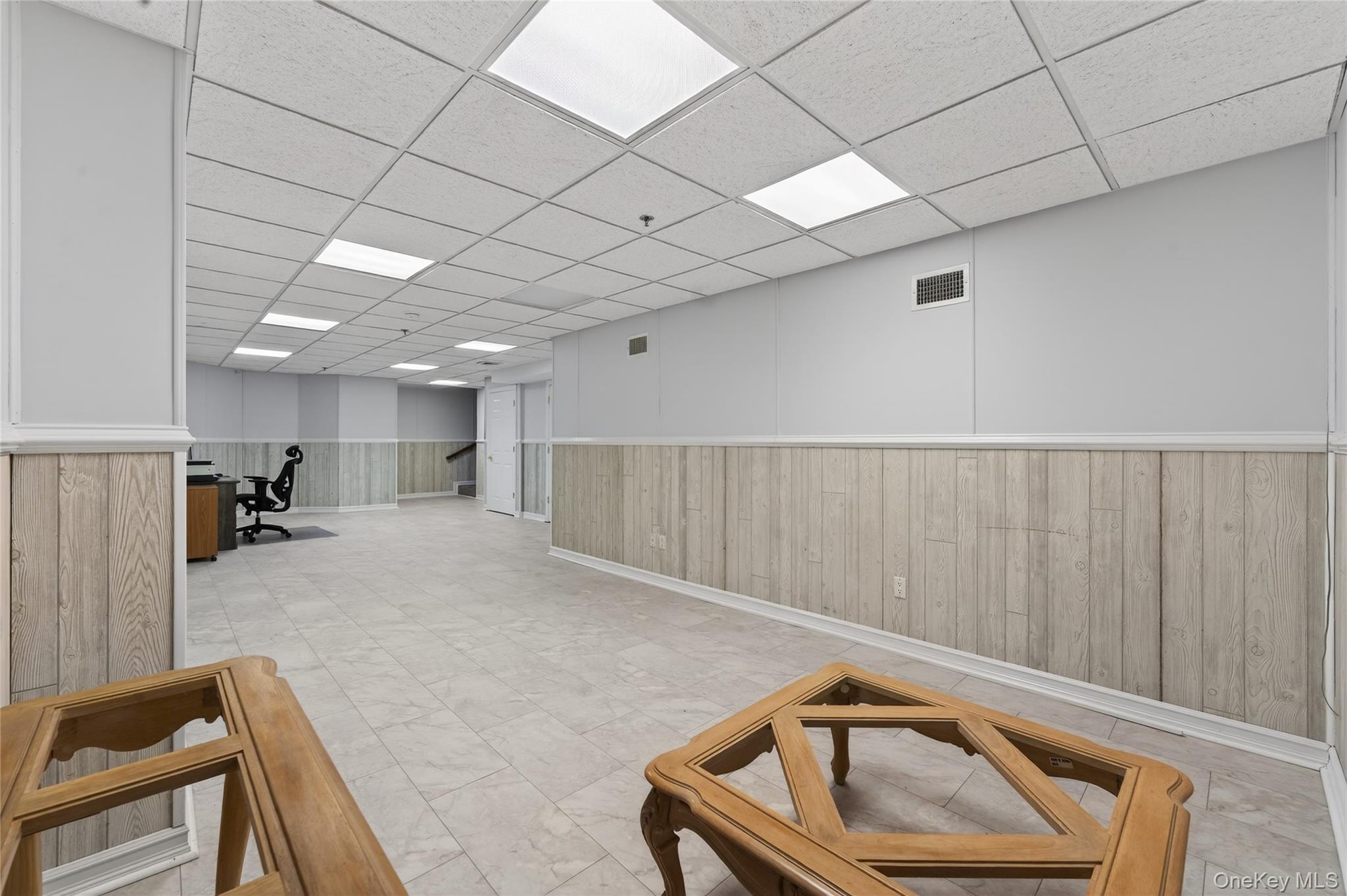 294 Spring Drive East Meadow, NY 11554 - Photo 20 of 31 Finished below grade area with wainscoting, wooden walls, and a drop ceiling