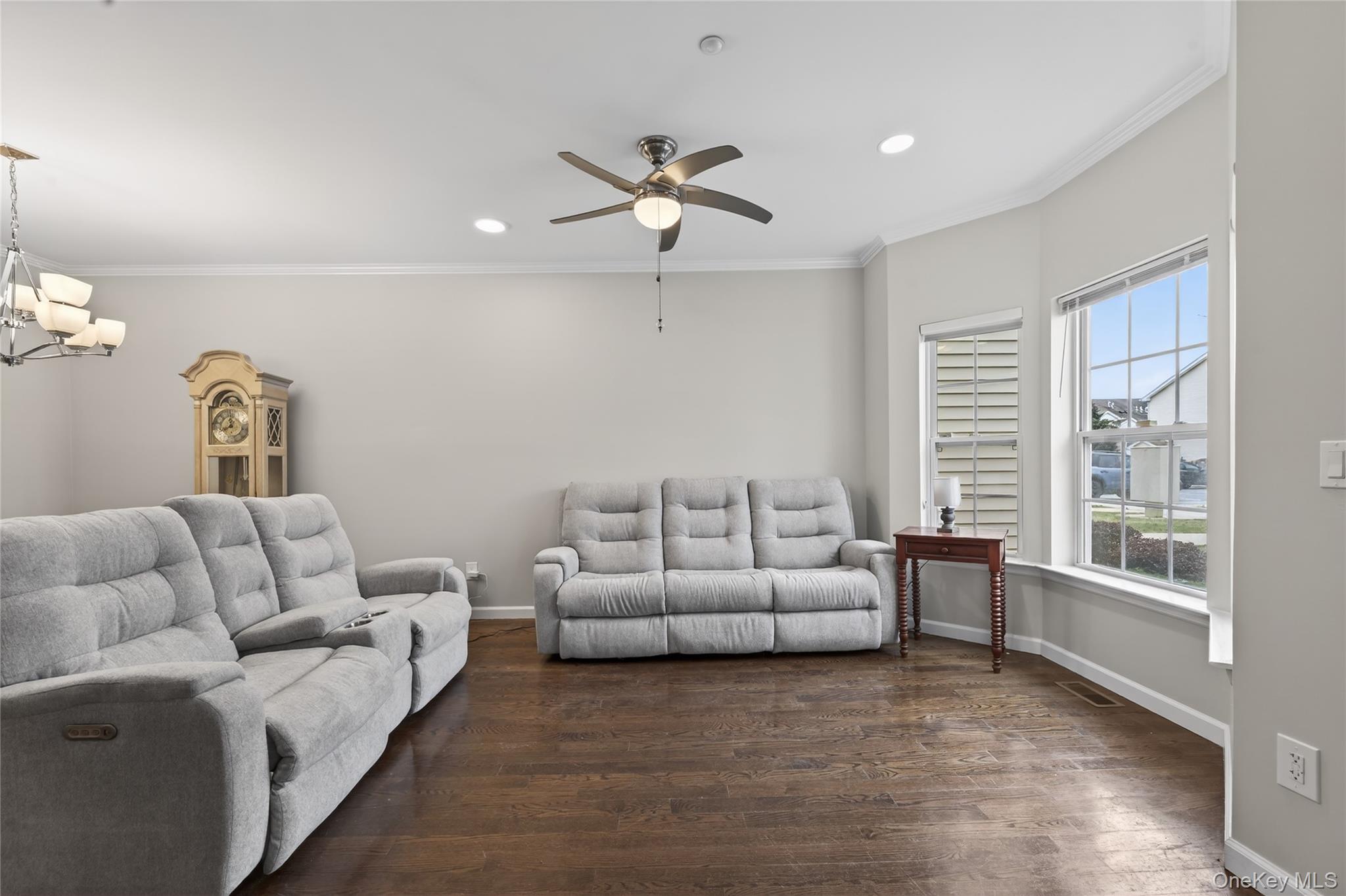 294 Spring Drive East Meadow, NY 11554 - Photo 2 of 31 Living area featuring crown molding, dark wood-style floors, a ceiling fan, recessed lighting, and a chandelier