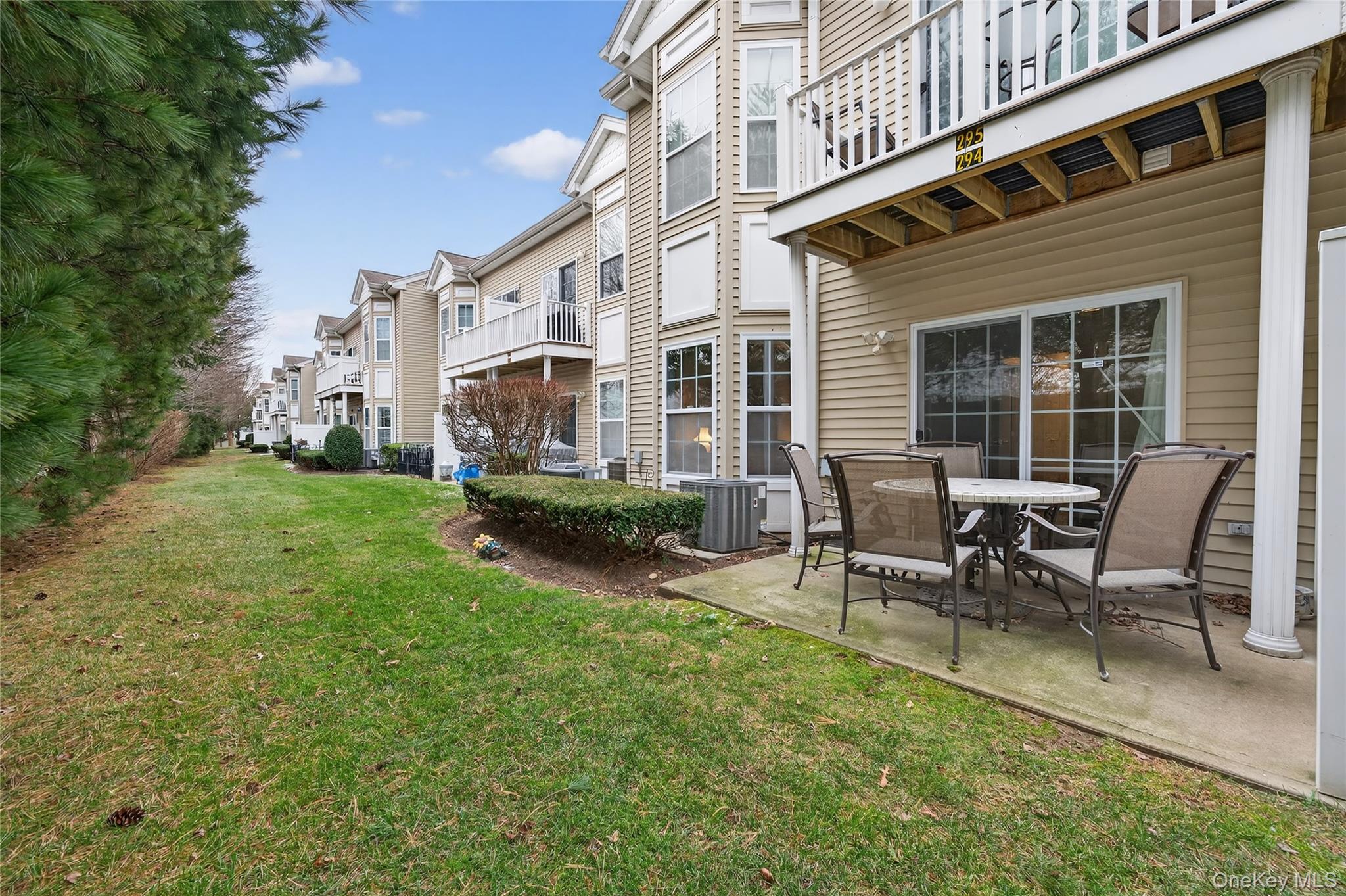 294 Spring Drive East Meadow, NY 11554 - Photo 22 of 31 View of grassy yard featuring a balcony and a patio area