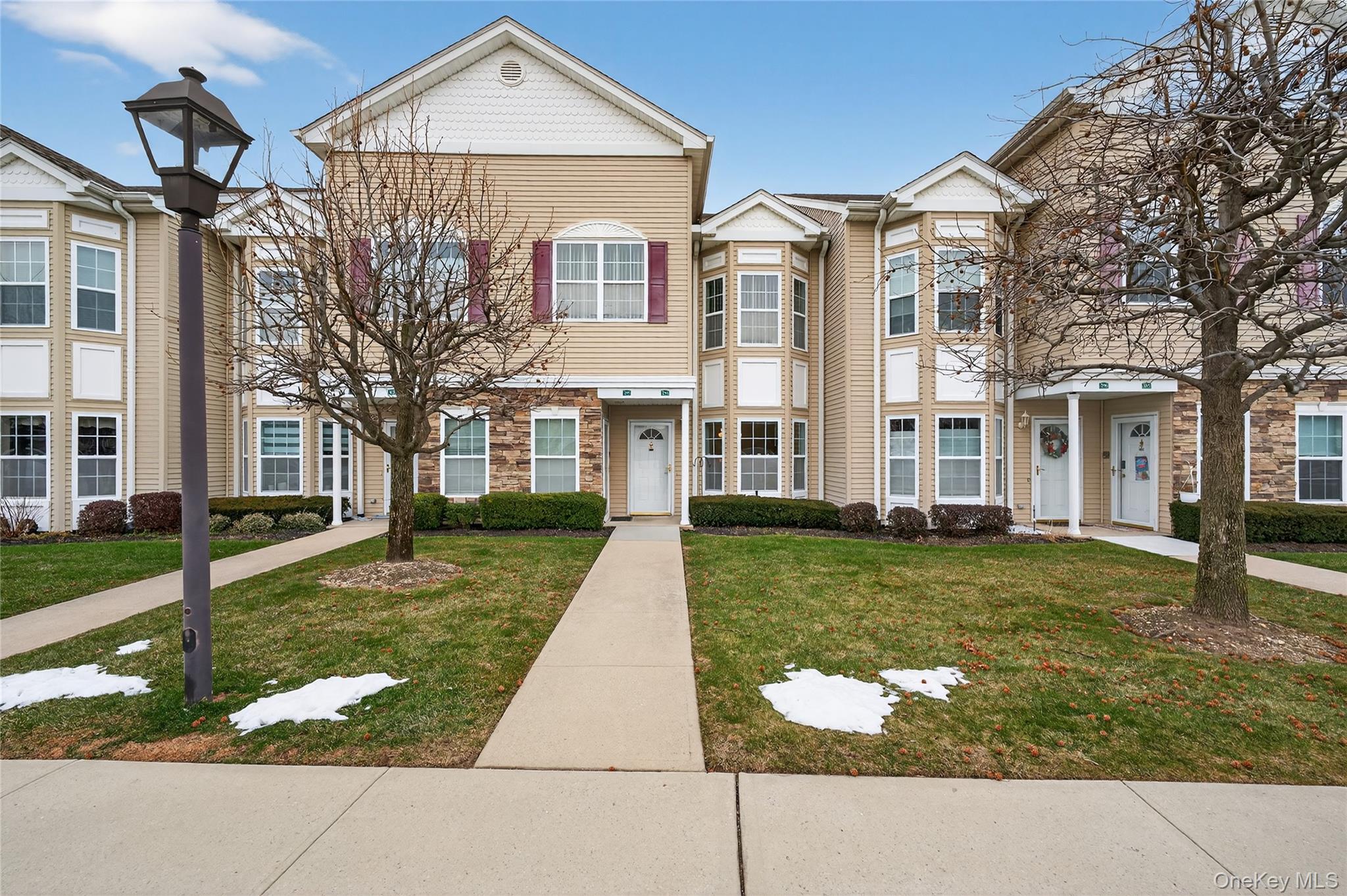 294 Spring Drive East Meadow, NY 11554 - Photo 26 of 31 Victorian house with a front lawn and stone siding