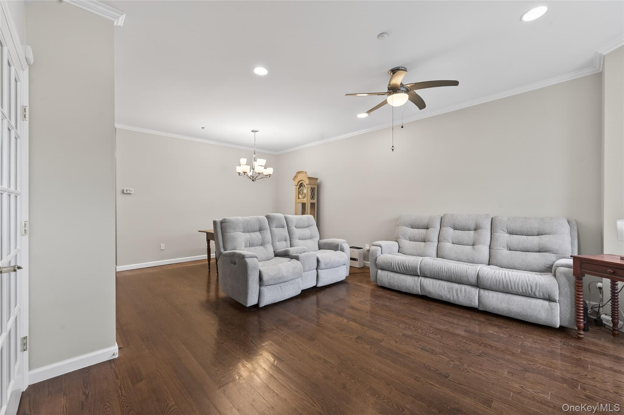 294 Spring Drive East Meadow, NY 11554 - Photo 3 of 31 Living area with ornamental molding, recessed lighting, dark wood-style flooring, ceiling fan, and a chandelier