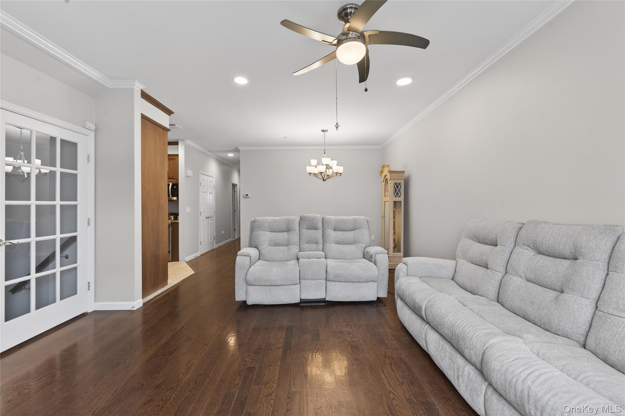 294 Spring Drive East Meadow, NY 11554 - Photo 4 of 31 Living room featuring ornamental molding, a chandelier, dark wood-style floors, a ceiling fan, and recessed lighting