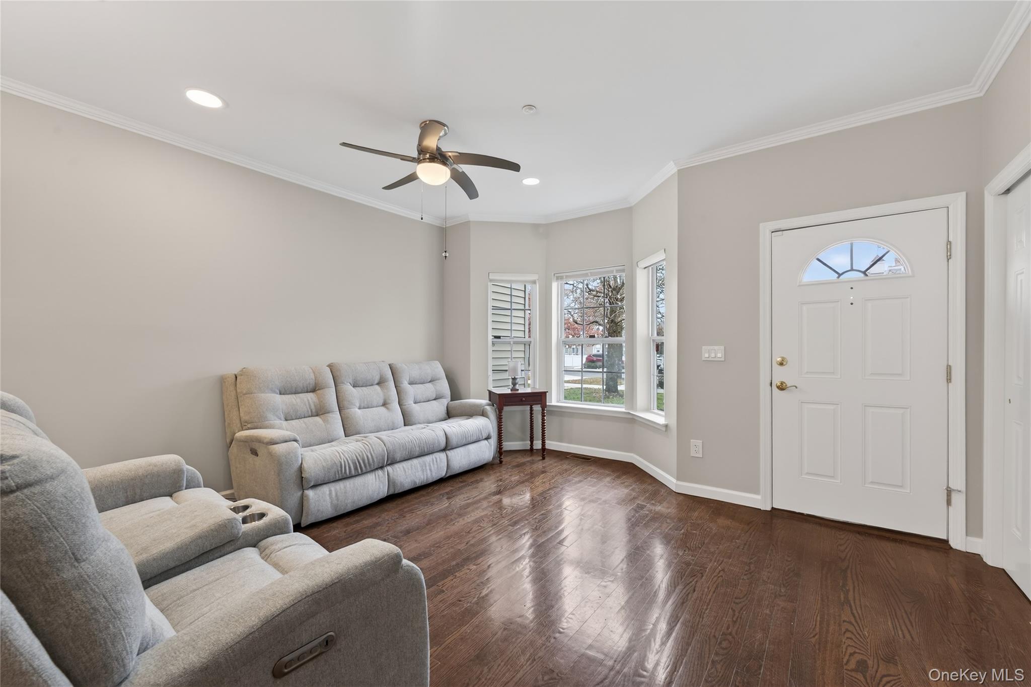 294 Spring Drive East Meadow, NY 11554 - Photo 5 of 31 Living room with crown molding, dark wood-style flooring, recessed lighting, and a ceiling fan