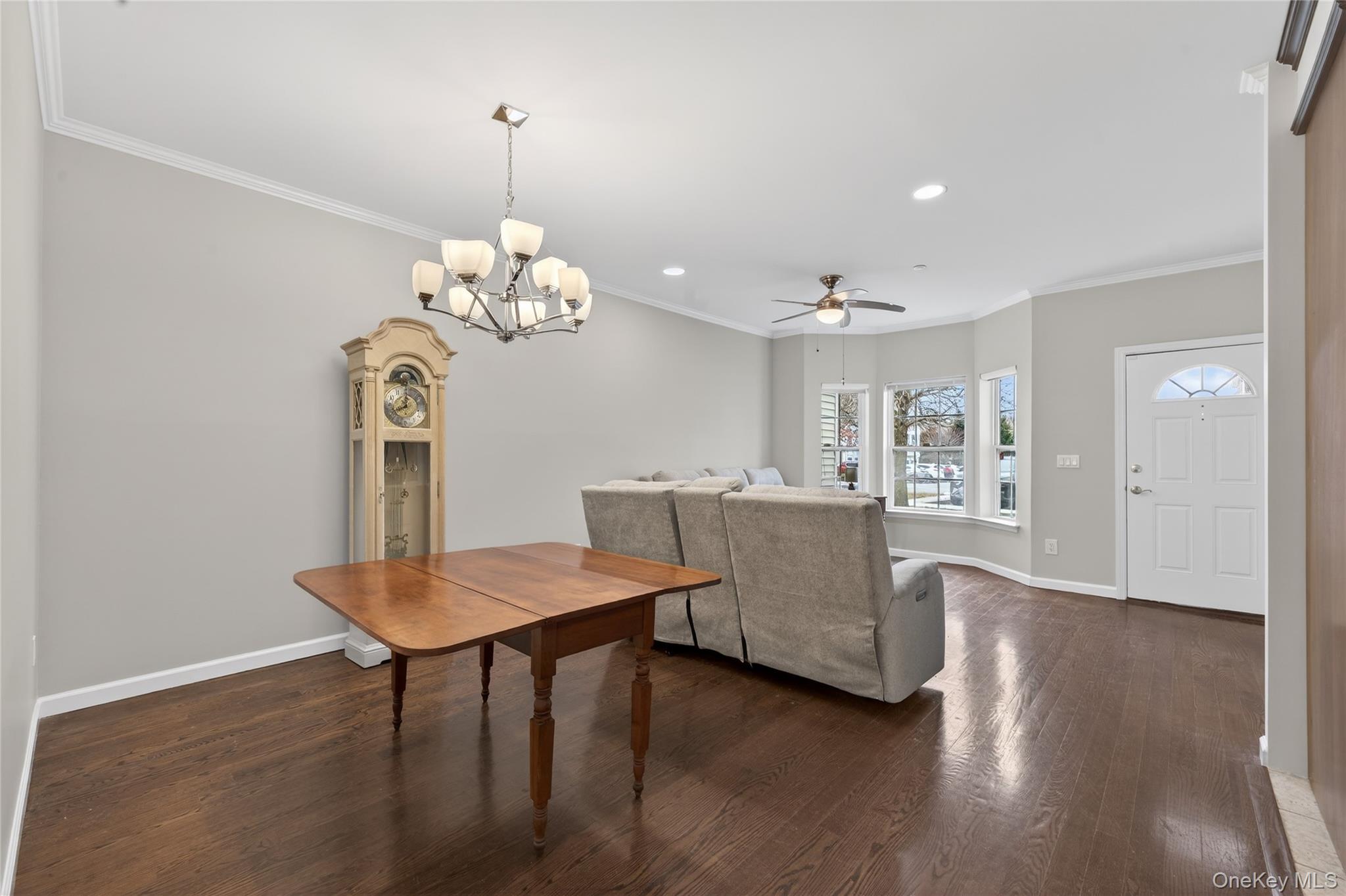 294 Spring Drive East Meadow, NY 11554 - Photo 6 of 31 Dining room with crown molding, recessed lighting, a ceiling fan, dark wood finished floors, and a chandelier