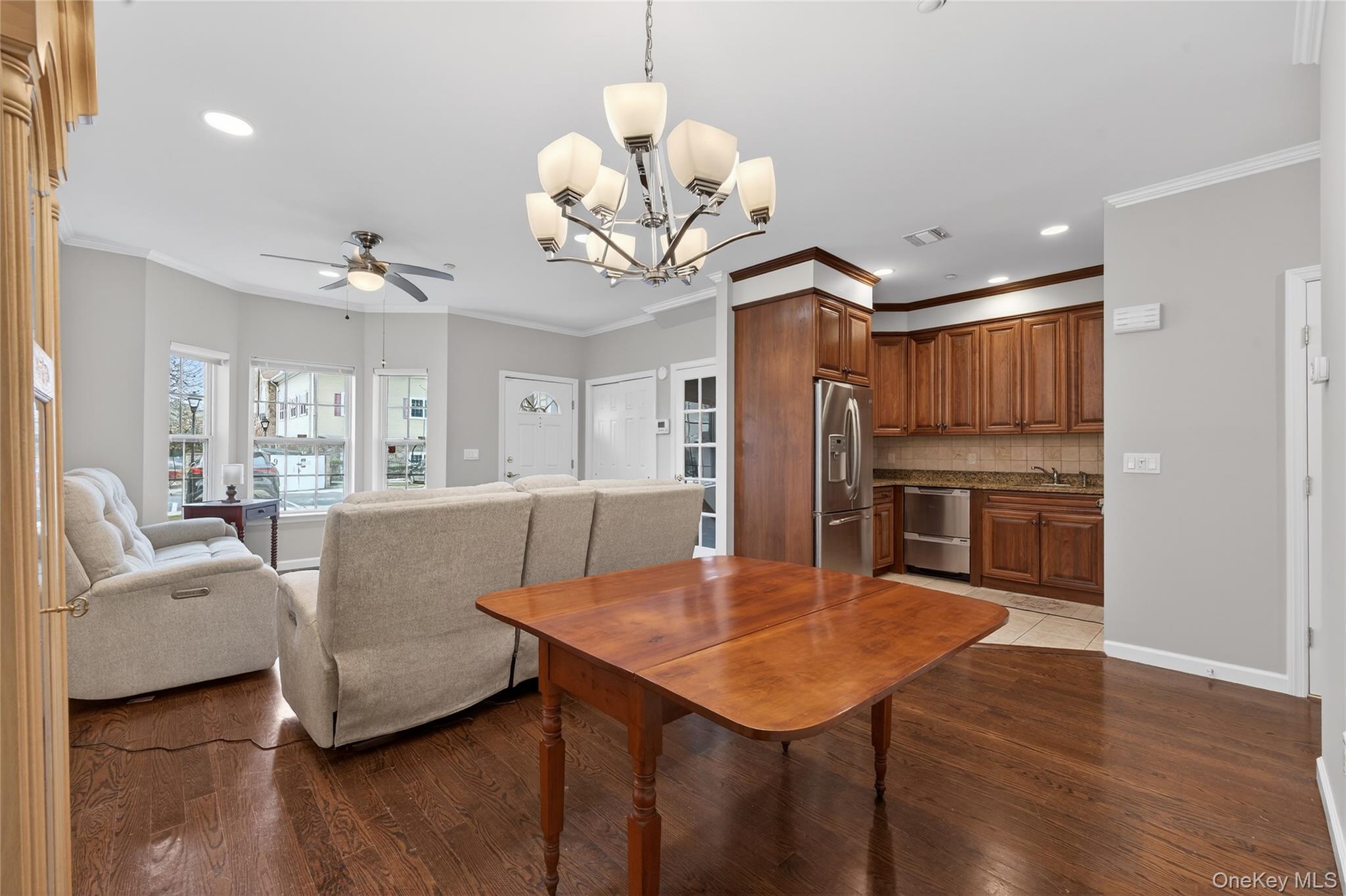 294 Spring Drive East Meadow, NY 11554 - Photo 7 of 31 Dining space with a chandelier, ornamental molding, dark wood-style flooring, recessed lighting, and ceiling fan
