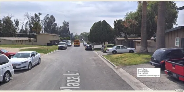 a couple of cars parked in front of a house