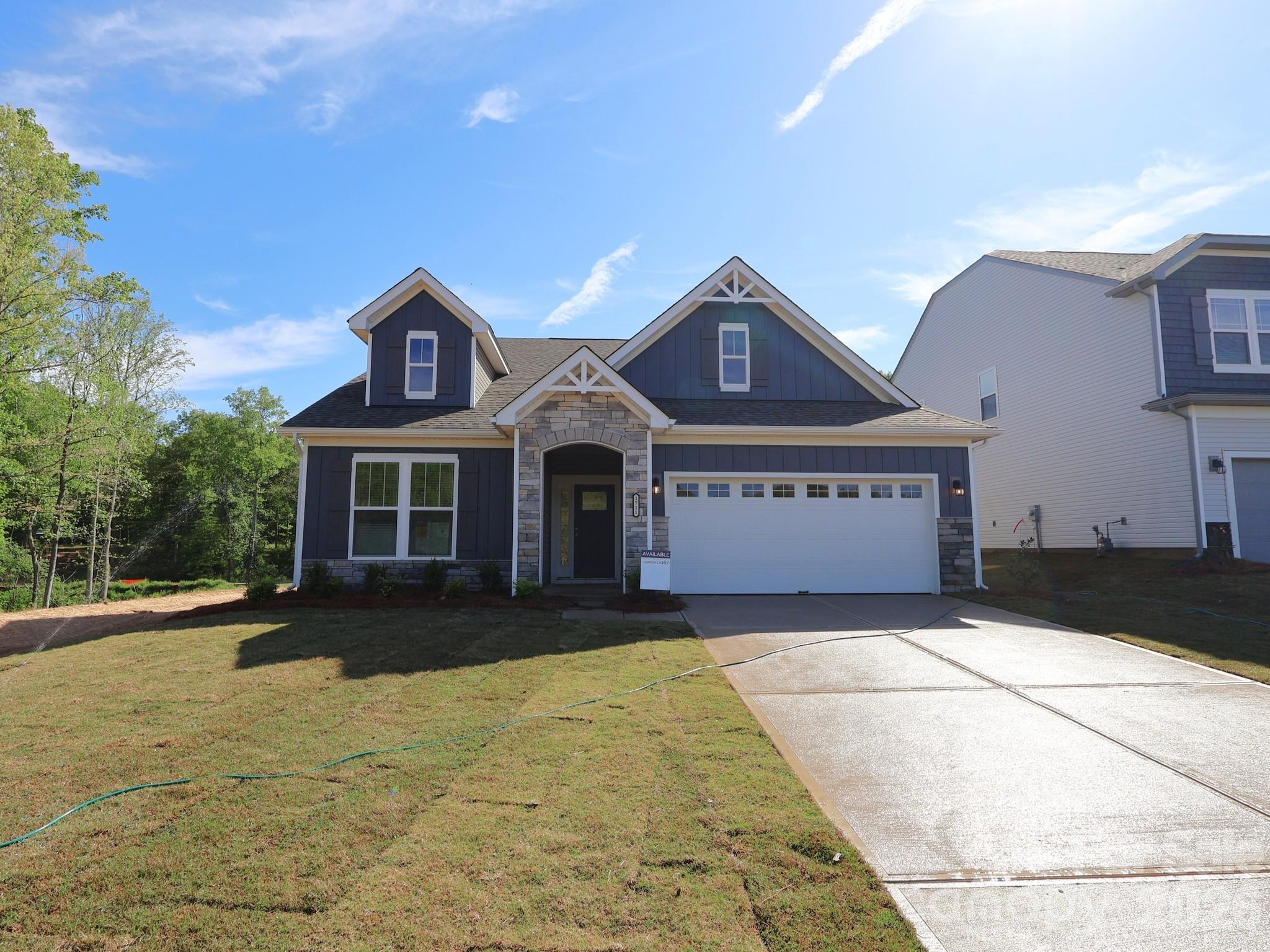 1711 Boulder Rdg Drive Gastonia, NC 28052 - Photo 1 of 8 a front view of a house with a yard and garage