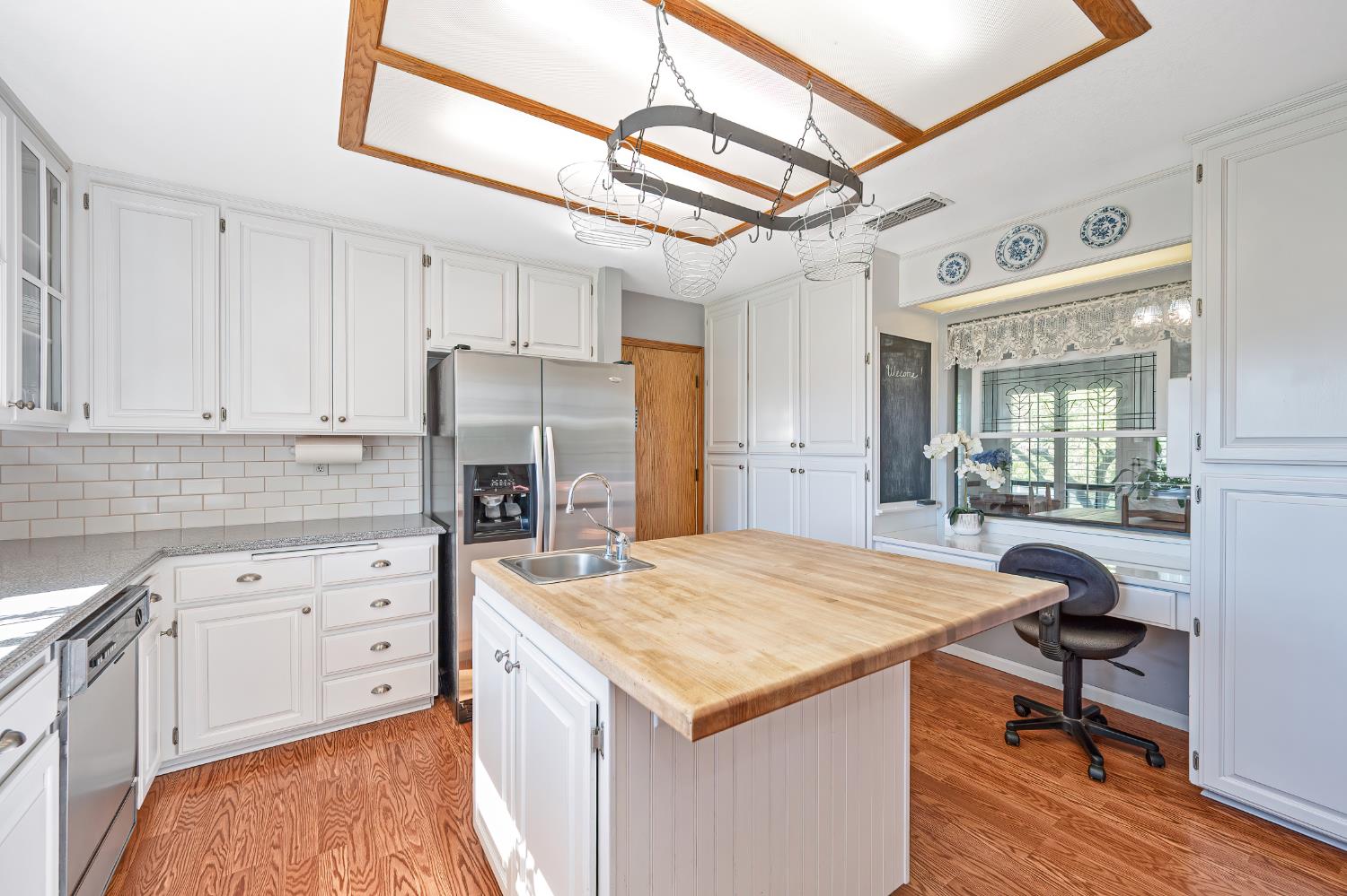 14470 Riva Ridge Circle Auburn, CA 95602 - Photo 18 of 71 a kitchen that has a lot of cabinets in it and wooden floors