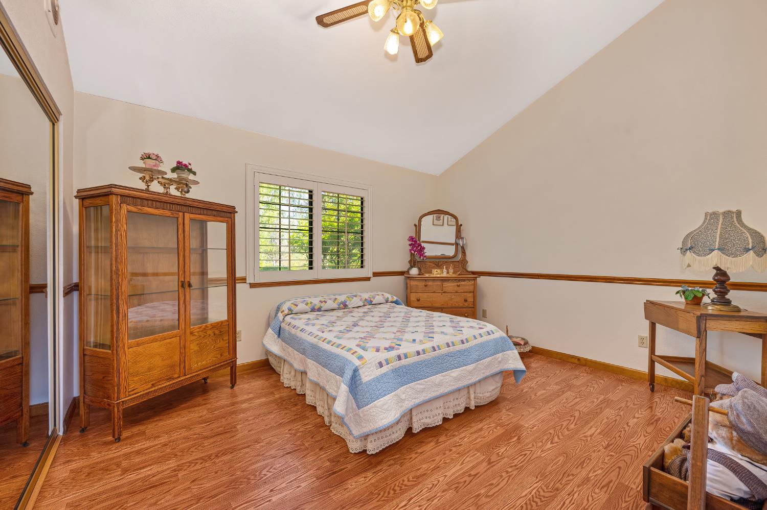 14470 Riva Ridge Circle Auburn, CA 95602 - Photo 20 of 71 a bedroom with a bed and a dresser next to a window