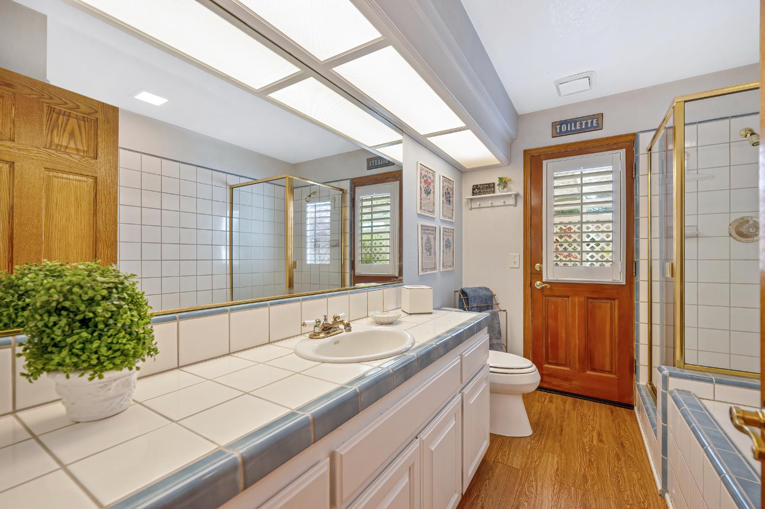 14470 Riva Ridge Circle Auburn, CA 95602 - Photo 21 of 71 a bathroom with a sink a toilet and a large mirror