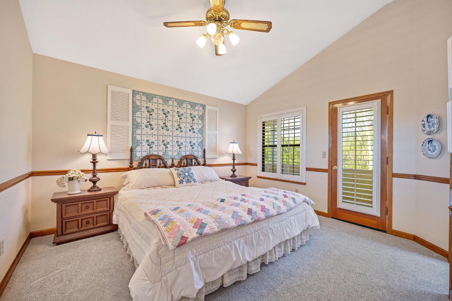 14470 Riva Ridge Circle Auburn, CA 95602 - Photo 24 of 71 a bedroom with a large bed and a chandelier