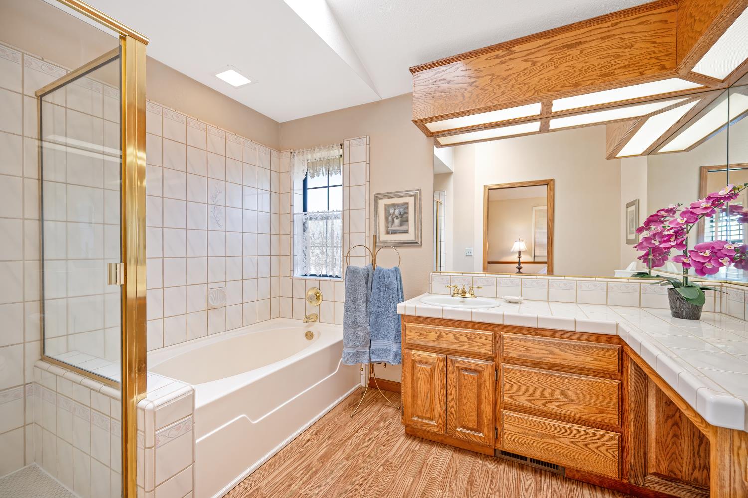 14470 Riva Ridge Circle Auburn, CA 95602 - Photo 27 of 71 a bathroom with a tub sink and mirror