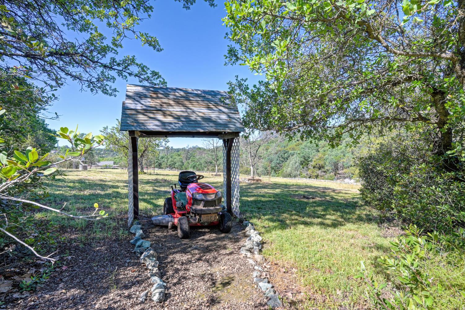 14470 Riva Ridge Circle Auburn, CA 95602 - Photo 65 of 71 a view of a wooden house with a big yard and sitting area