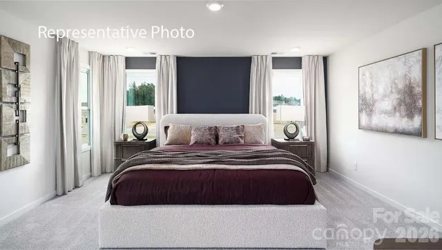 a bedroom with a large bed and a large window