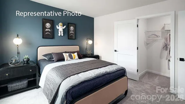 a bedroom with a bed and a painting on the wall