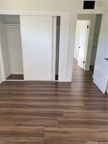 a view of room with window and wooden floor