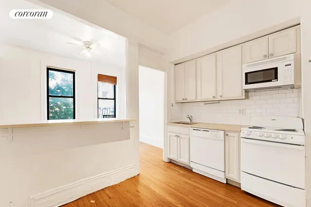 a view of an empty room and wooden floor