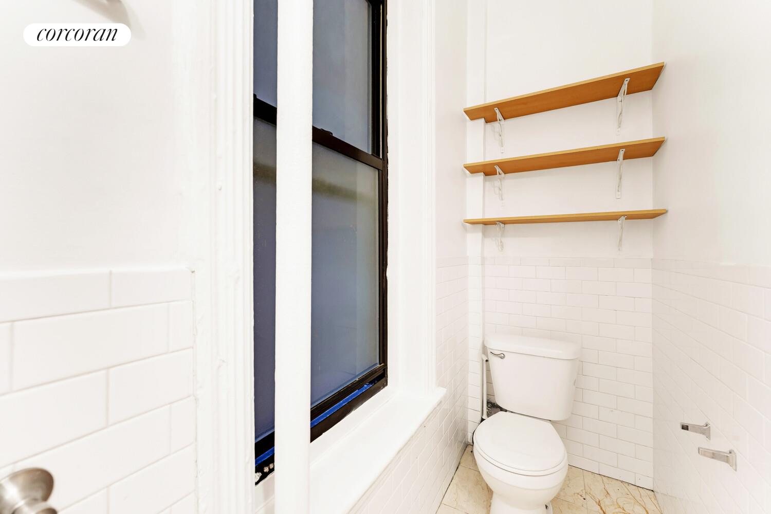 192 Bleecker Street, Unit 14 Manhattan, NY 10012 - Photo 16 of 17 a white toilet sitting next to a bathroom sink