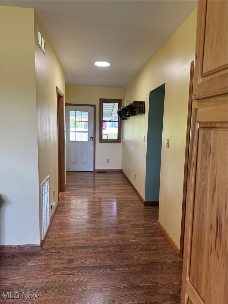 6255 Highland Ridge Road Lowell, OH 45744 - Photo 10 of 40 Hallway featuring dark wood-style flooring and baseboards