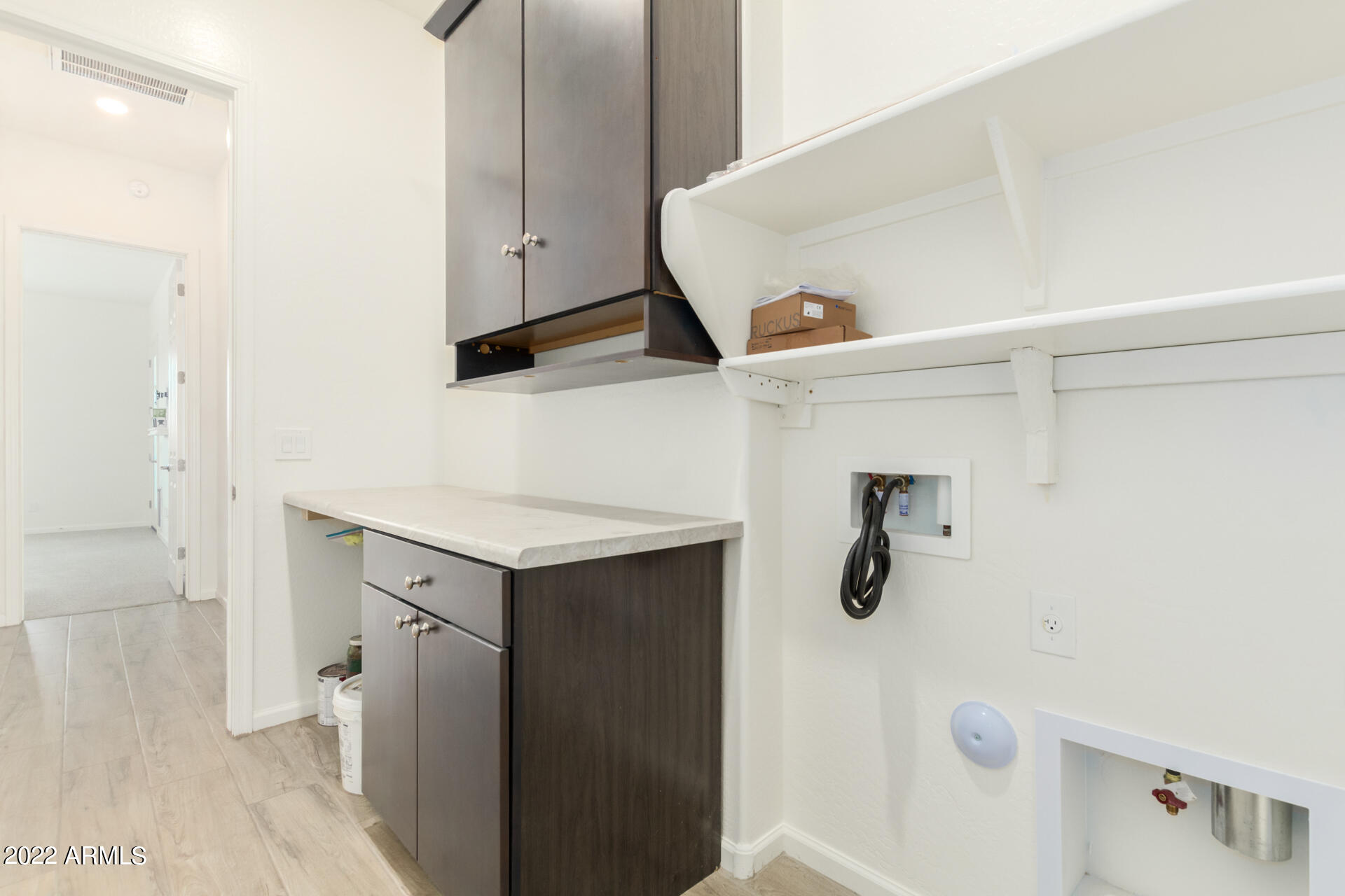 18545 West Chuckwalla Canyon Road Goodyear, AZ 85338 - Photo 34 of 66 Laundry room with storage