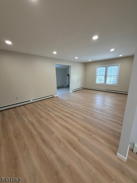 55 Highway 181 Lake Hopatcong, NJ 07849 - Photo 3 of 10 an empty room with wooden floor and windows