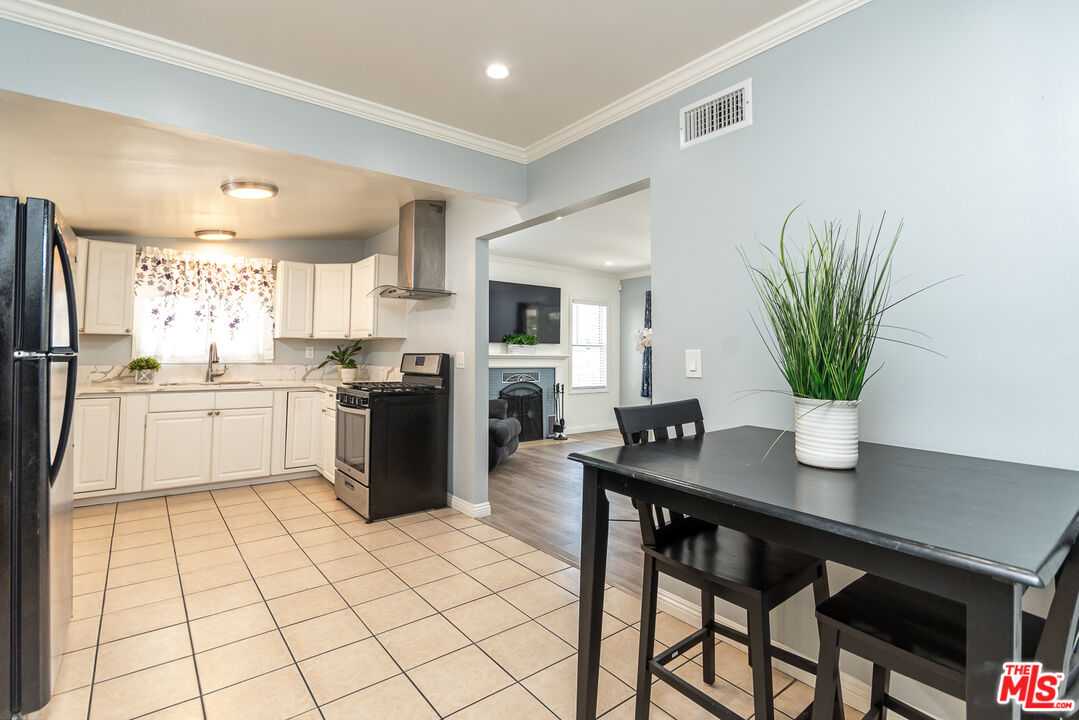 10307 Eldora Avenue Sunland, CA 91040 - Photo 12 of 32 a kitchen with a refrigerator a sink and cabinets