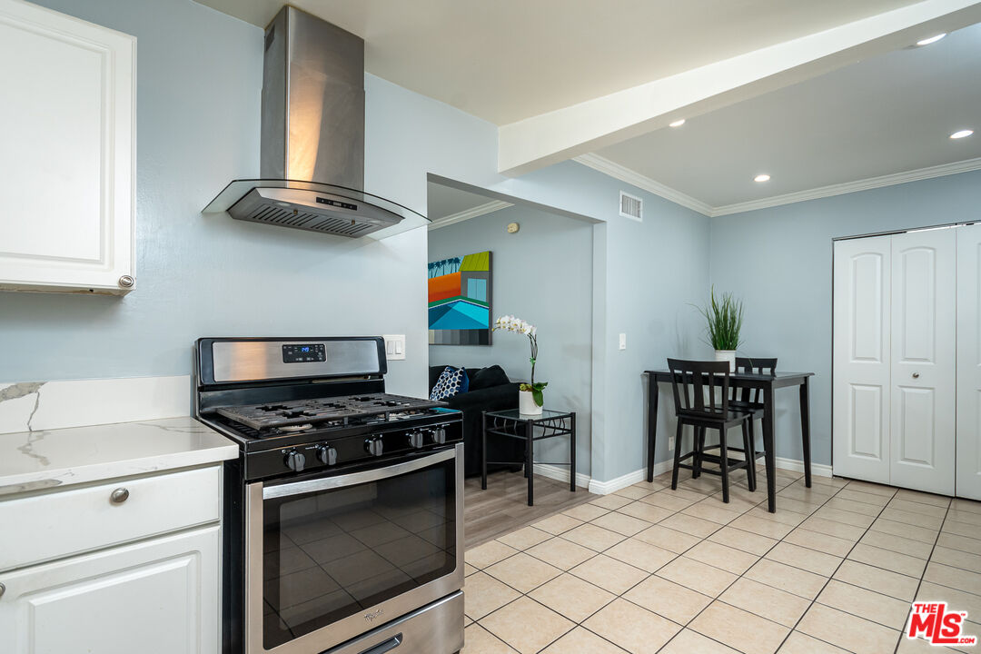 10307 Eldora Avenue Sunland, CA 91040 - Photo 16 of 32 a kitchen with stainless steel appliances a stove a sink and a refrigerator