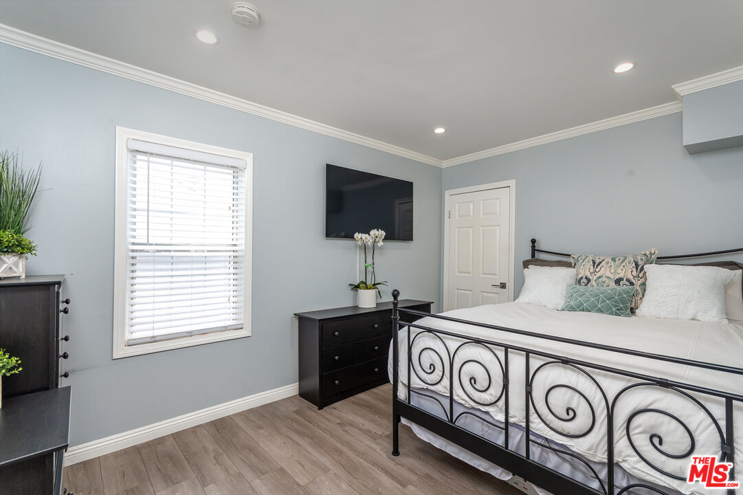 10307 Eldora Avenue Sunland, CA 91040 - Photo 5 of 32 a bedroom with a bed and a chandelier