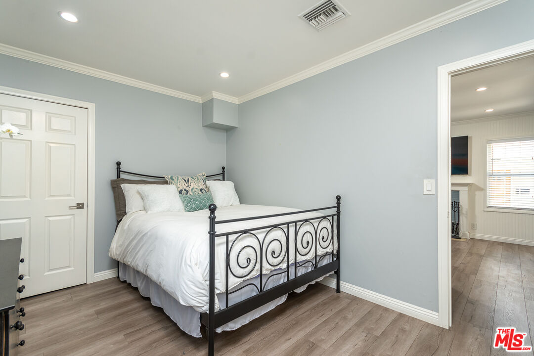 10307 Eldora Avenue Sunland, CA 91040 - Photo 6 of 32 a bedroom with a bed and wooden floor