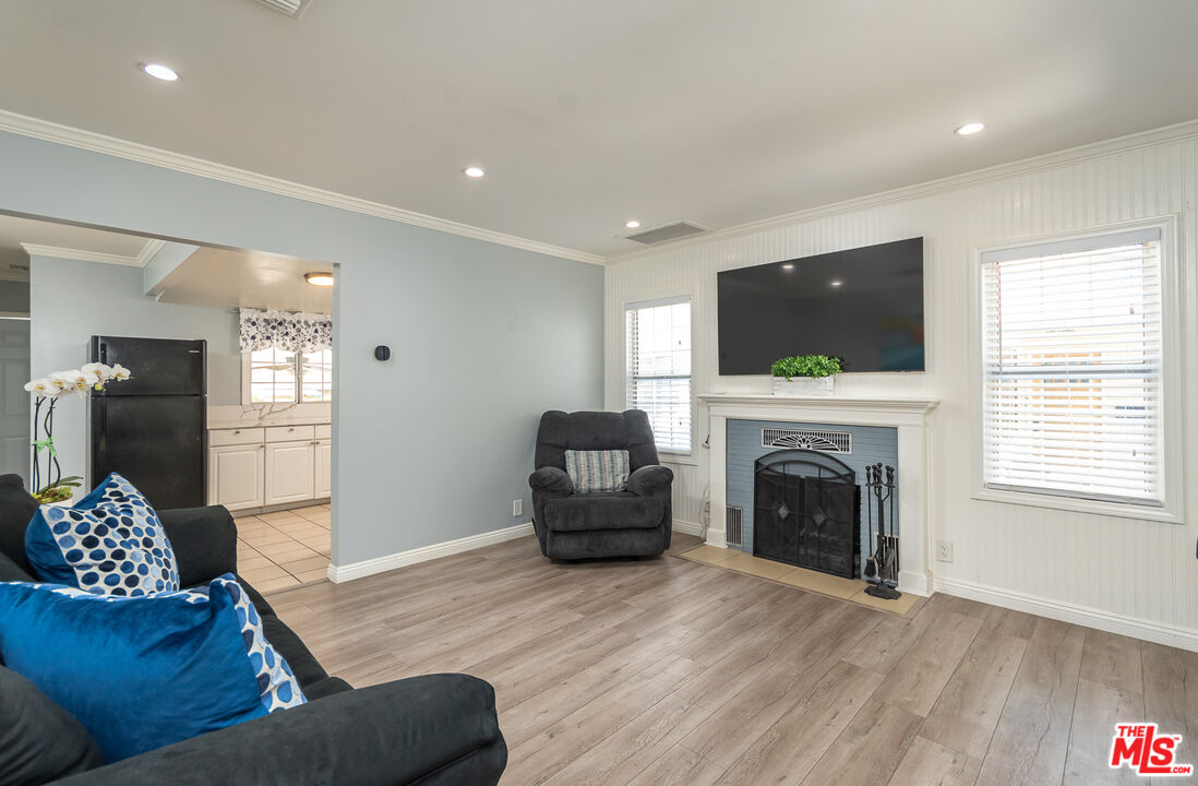10307 Eldora Avenue Sunland, CA 91040 - Photo 8 of 32 a living room with furniture a flat screen tv and a fireplace