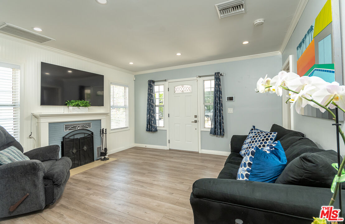 10307 Eldora Avenue Sunland, CA 91040 - Photo 9 of 32 a living room with furniture a fireplace and a flat screen tv