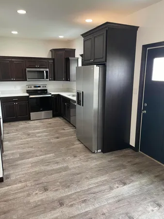 a kitchen with a refrigerator and a sink