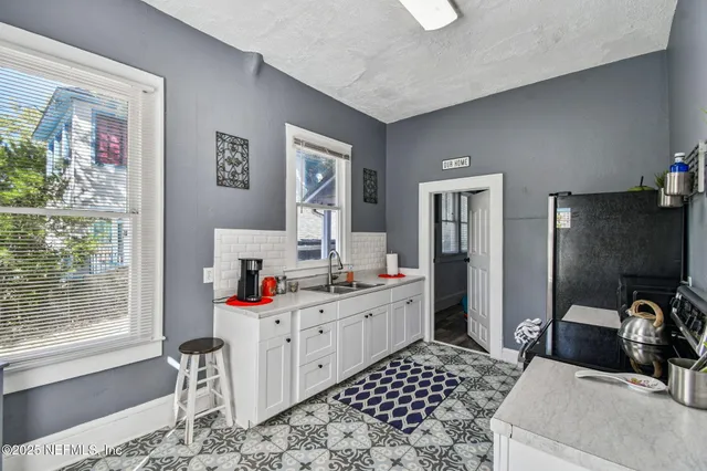 a room with furniture a flat screen tv and a window