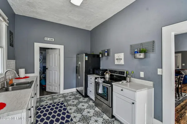 a kitchen with a refrigerator and a window