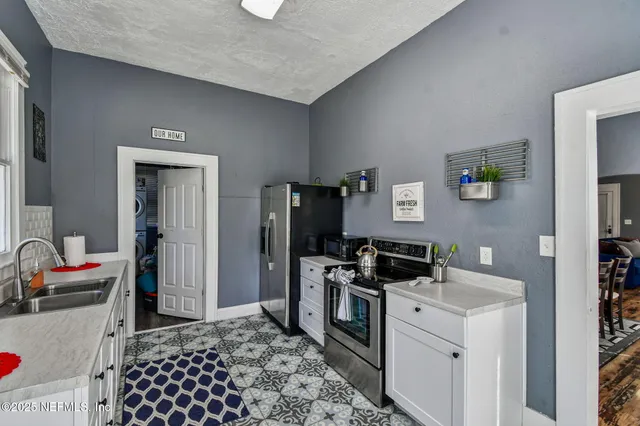 a kitchen with a refrigerator and a window
